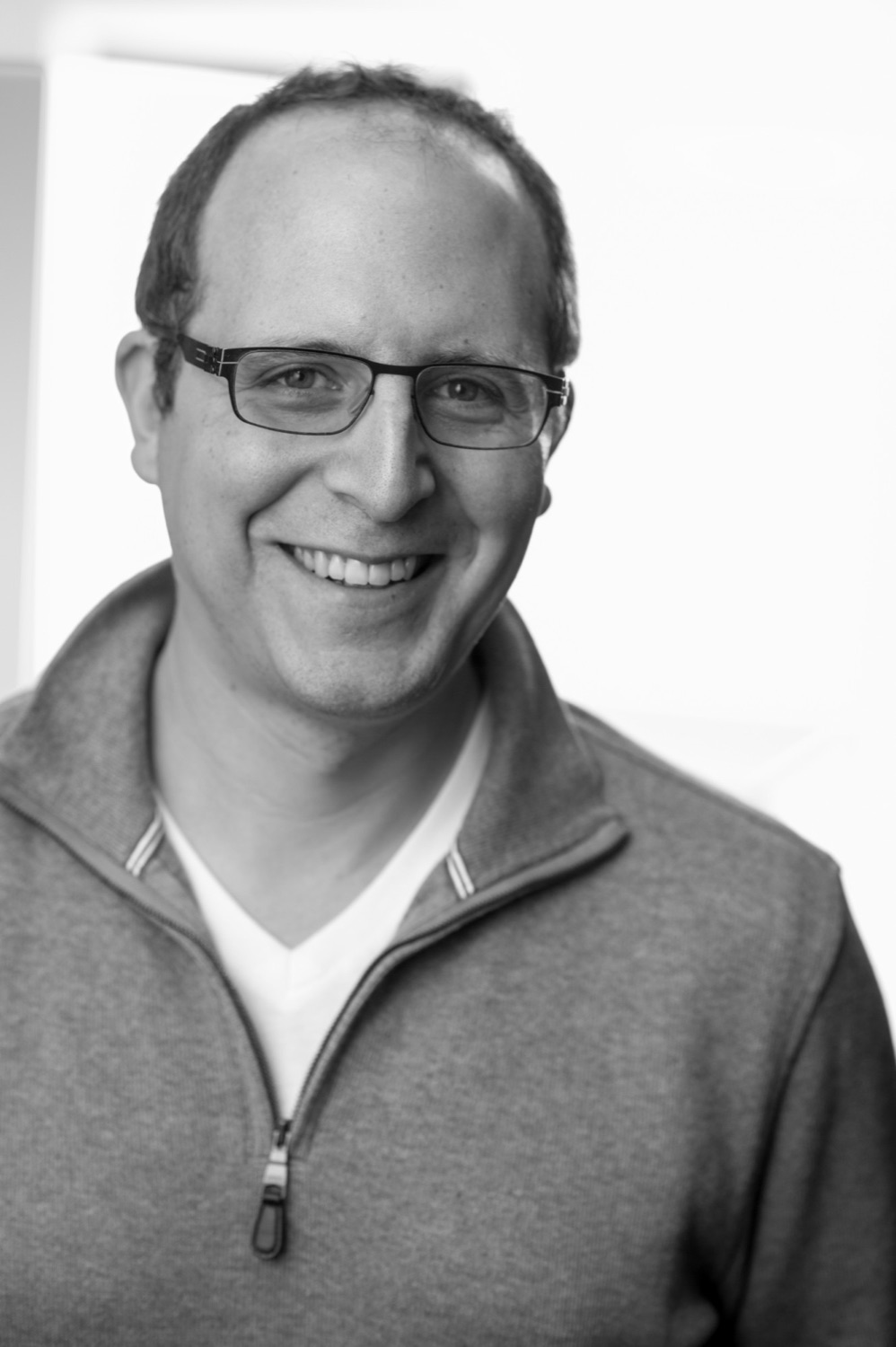 Daniel Schwartz, smiling, in a black-and-white portrait